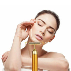 Gold facial roller for rejuvenating skin and enhancing beauty with luxurious skincare tools.