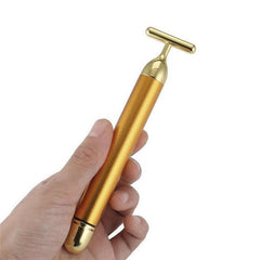 Gold facial roller for rejuvenating skin and enhancing beauty with luxurious skincare tools.